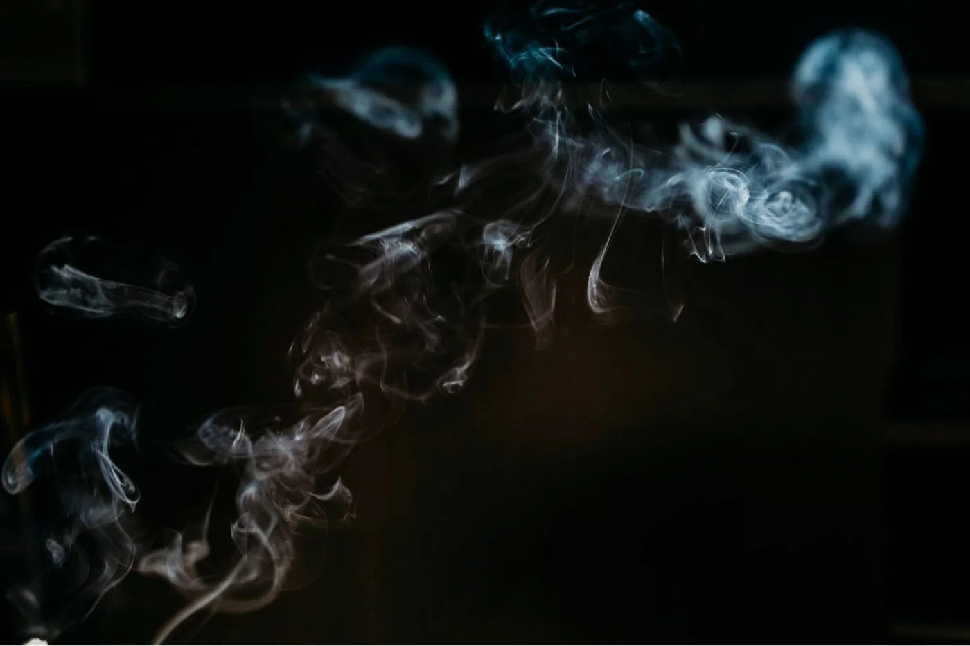 Smoke and light used as a visual symbol for energetic property clearing