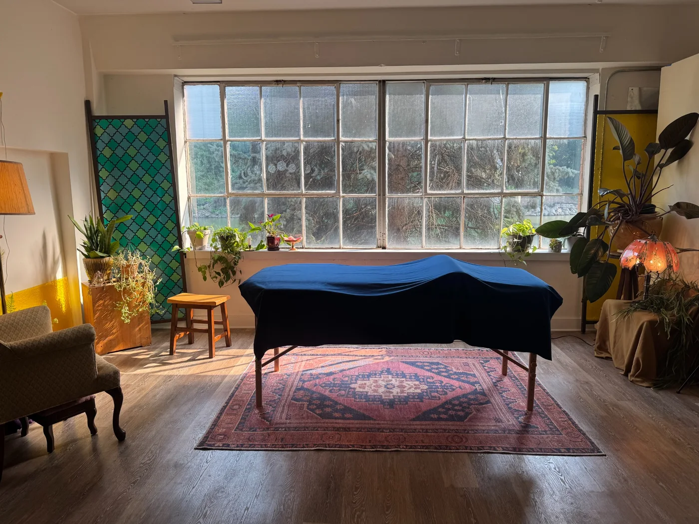 Ramaste Reiki session space with treatment table and warm window light